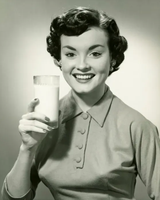 Framed Print : Young woman holding glass of milk, (B&W), portrait Framed Print : Young woman holding glass of milk, (B&W), portrait