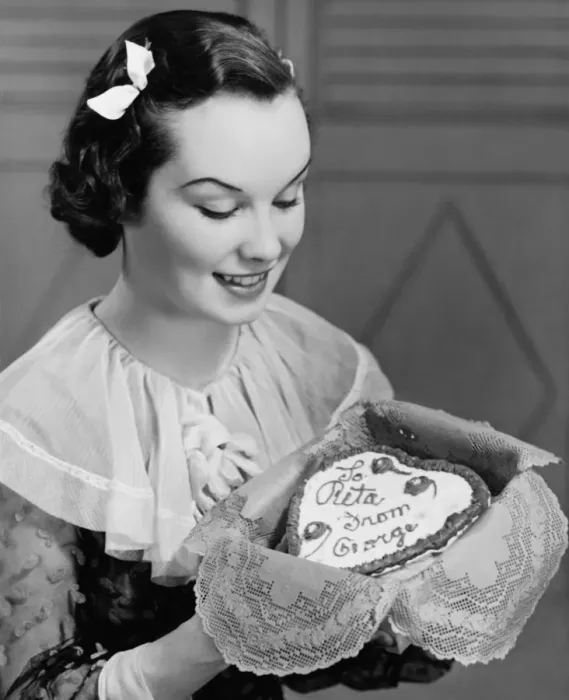 Framed Print : Young woman holding heart-shaped cake, (B&W) Framed Print : Young woman holding heart-shaped cake, (B&W)