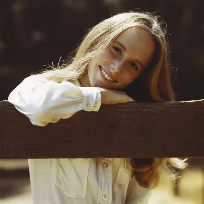 Framed Print : Young woman leaning on fence, smiling, portrait, close-up Framed Print : Young woman leaning on fence, smiling, portrait, close-up