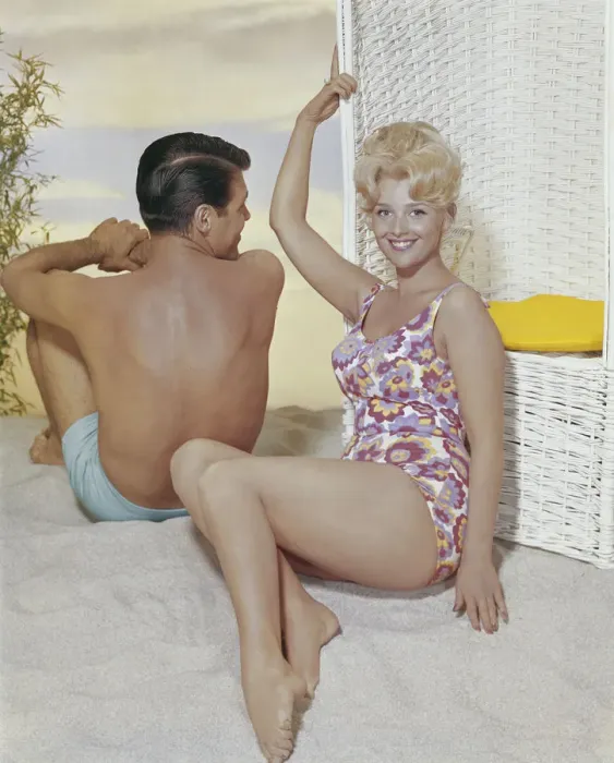 Framed Print : Young woman leaning on swing chair beside man, smiling Framed Print : Young woman leaning on swing chair beside man, smiling
