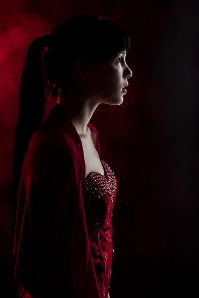 Young woman with long black hair in a red dress