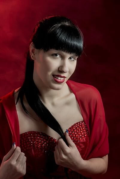 Young woman with long black hair in a red dress, portrait
