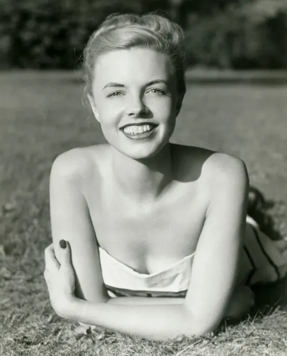 Framed Print : Young woman lying on grass, smiling, portrait