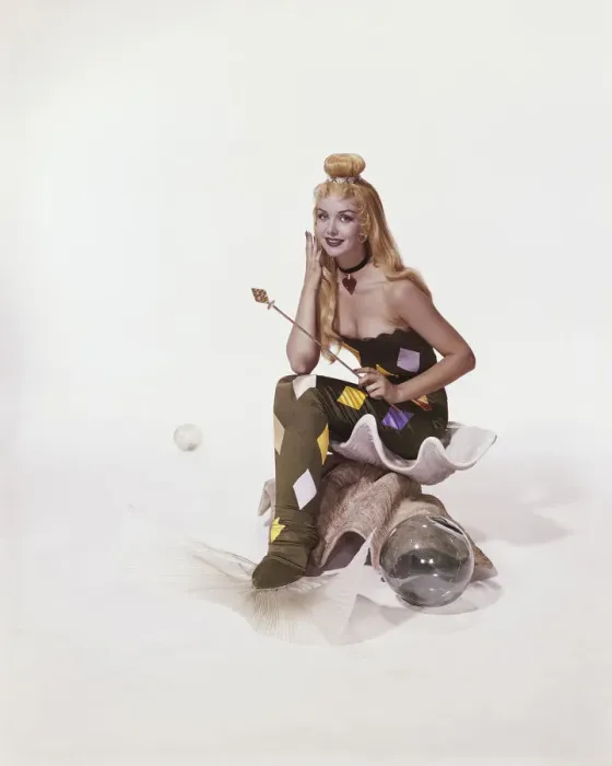 Framed Print : Young woman in mermaid costume sitting on shell, smiling, portrait Framed Print : Young woman in mermaid costume sitting on shell, smiling, portrait