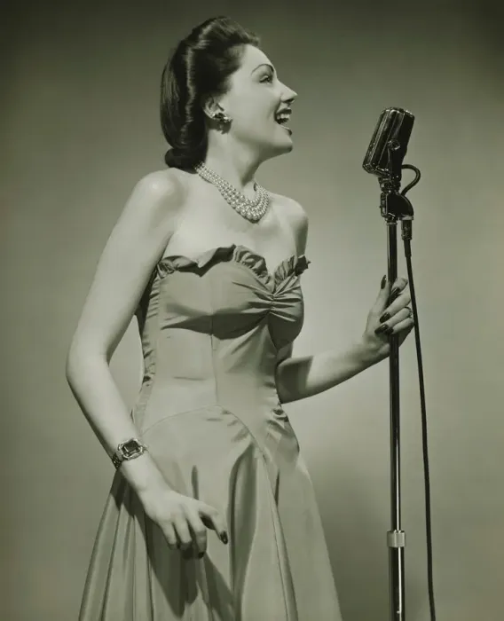 Framed Print : Young woman at microphone, singing, (B&W) Framed Print : Young woman at microphone, singing, (B&W)