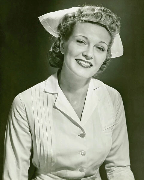 Young woman in nurse clothing smiling, (B&W)