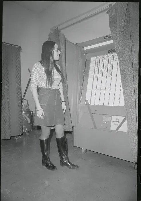 Framed Print : Young Woman Observing Voting Machine Framed Print : Young Woman Observing Voting Machine