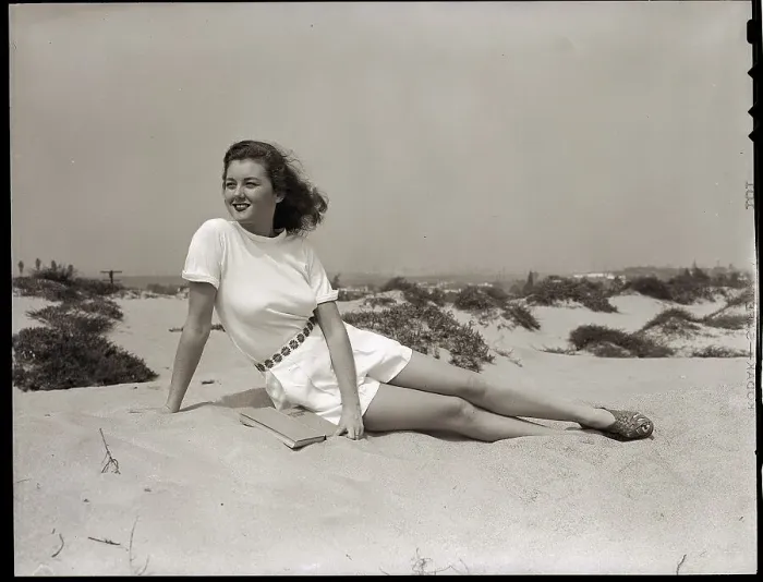 Framed Print : Young Woman Seated on the Beach Framed Print : Young Woman Seated on the Beach