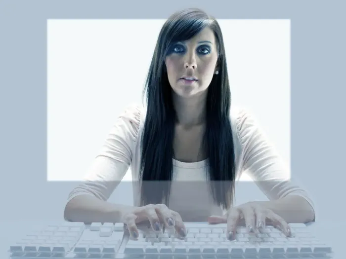 Framed Print : Young woman seen through the display of a computer while using the keyboard Framed Print : Young woman seen through the display of a computer while using the keyboard