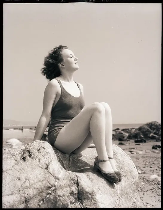 Framed Print : Young Woman Sitting on Beach Rocks Framed Print : Young Woman Sitting on Beach Rocks