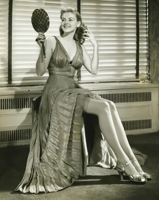 Framed Print : Young woman sitting on stool, holding mirror indoors, (B&W) Framed Print : Young woman sitting on stool, holding mirror indoors, (B&W)
