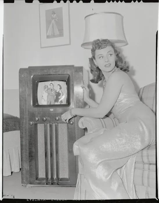 Framed Print : Young Woman Sitting Next to Television Framed Print : Young Woman Sitting Next to Television