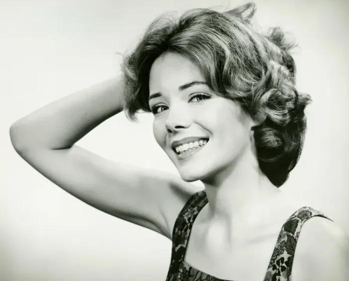 Framed Print : Young woman smiling, holding hand on head (B&W), (Portrait) Framed Print : Young woman smiling, holding hand on head (B&W), (Portrait)