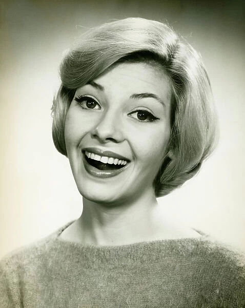 Young woman smiling, posing in studio, (B&W), (Portrait)