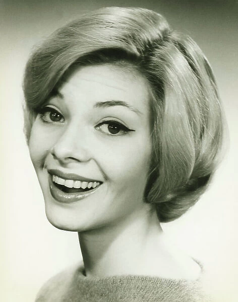 Young woman smiling, posing in studio, (B&W), (Portrait)
