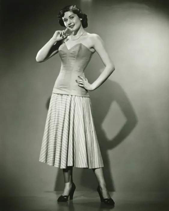 Framed Print : Young woman standing in studio, smiling, (B&W) Framed Print : Young woman standing in studio, smiling, (B&W)