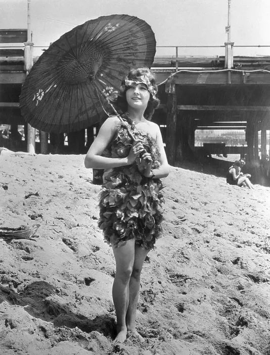 Framed Print : Young woman in stylish swimming costume posing on sandy beach Framed Print : Young woman in stylish swimming costume posing on sandy beach