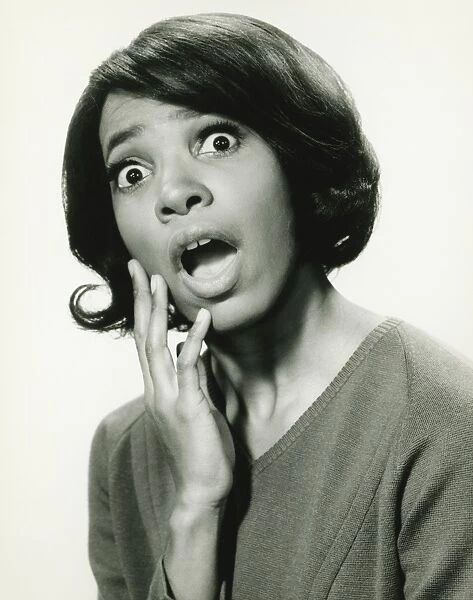 Young woman with surprised expression, (B&W), close-up