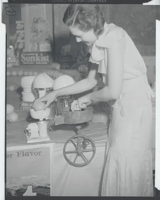 Framed Print : Young Woman Using Early Orange Juice Machine Framed Print : Young Woman Using Early Orange Juice Machine