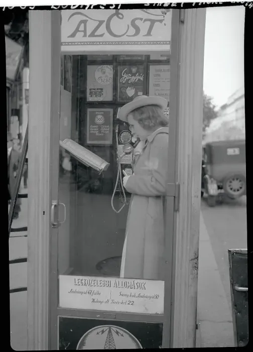 Framed Print : Young Woman Using Public Telephone Framed Print : Young Woman Using Public Telephone