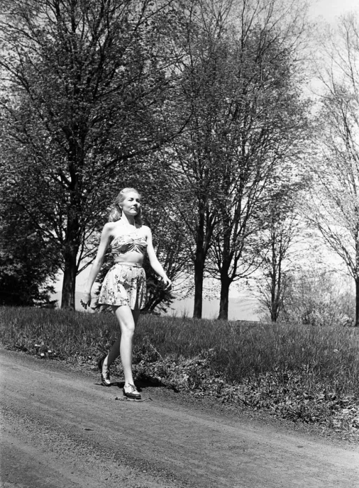 Framed Print : Young woman walking along country road Framed Print : Young woman walking along country road