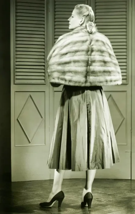 Framed Print : Young woman wearing fur standing in empty room, (B&W) Framed Print : Young woman wearing fur standing in empty room, (B&W)