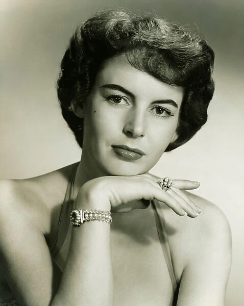 Young woman wearing pearl jewellery, (B&W), portrait