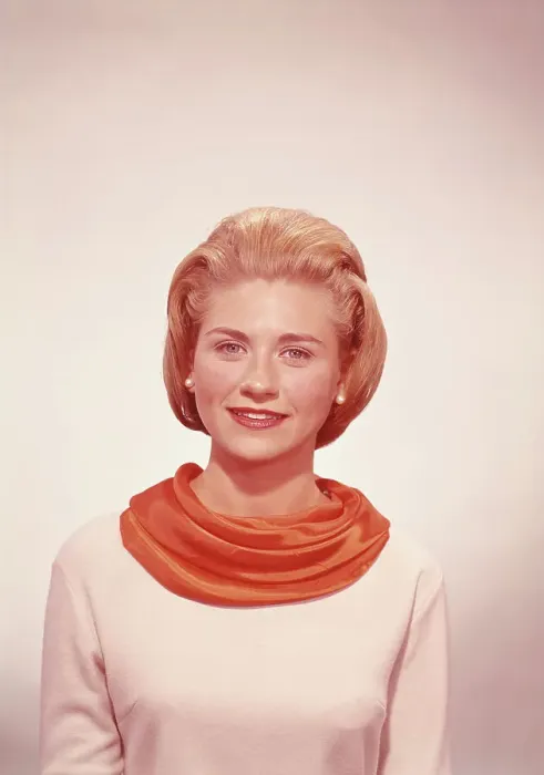 Framed Print : Young woman wearing scarf in studio, smiling Framed Print : Young woman wearing scarf in studio, smiling
