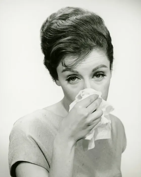 Framed Print : Young woman wiping nose with handkerchief, posing in studio, (B&W), (Portrait) Framed Print : Young woman wiping nose with handkerchief, posing in studio, (B&W), (Portrait)