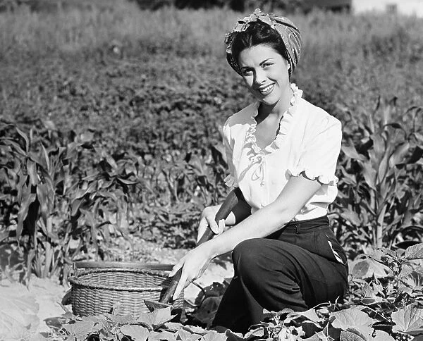 Young woman working in field, (B&W), portrait