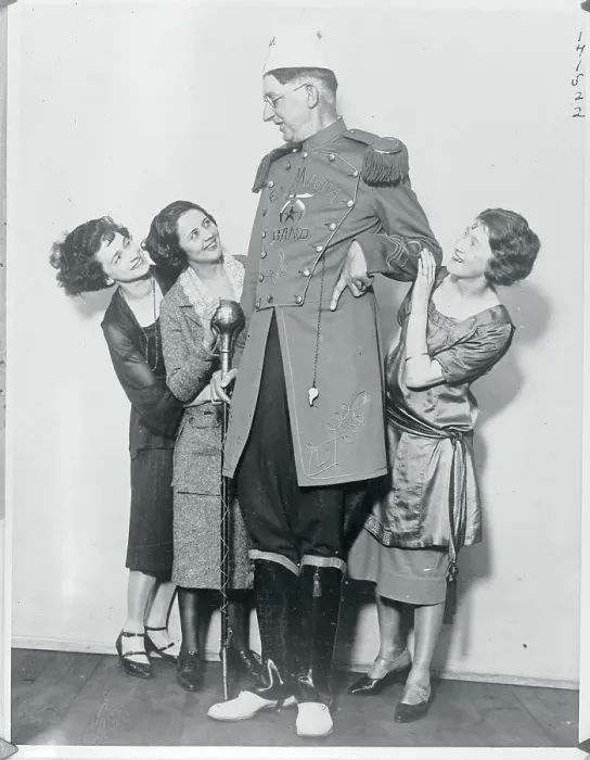 Framed Print : Young Women Embracing Very Tall Gentleman Framed Print : Young Women Embracing Very Tall Gentleman