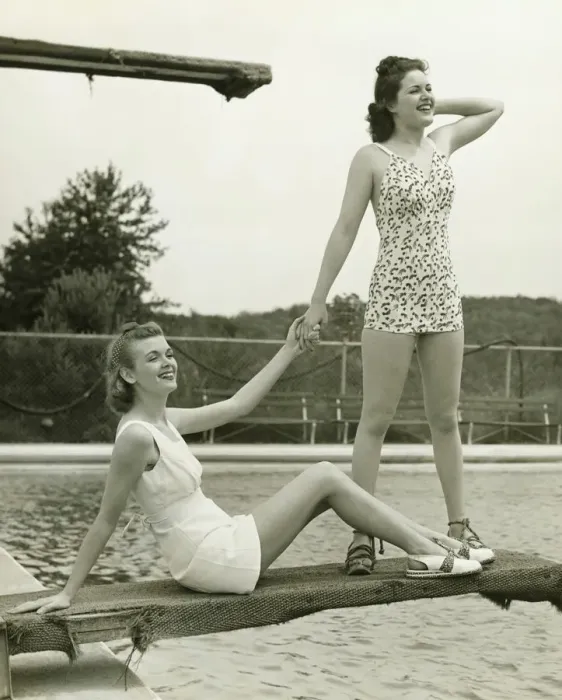 Framed Print : Two young women holding hands on springboard, (B&W) Framed Print : Two young women holding hands on springboard, (B&W)