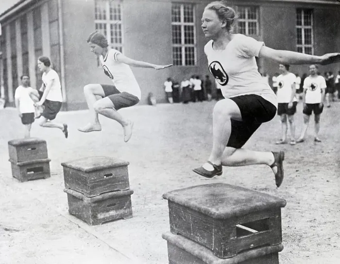 Framed Print : Young Women Hurdling Over Low Obstacles Framed Print : Young Women Hurdling Over Low Obstacles