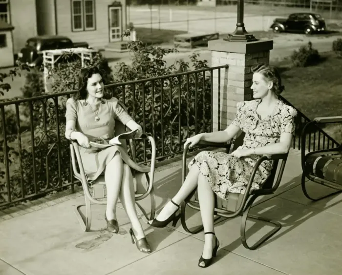 Framed Print : Two young women sitting on terrace, talking, (B&W) Framed Print : Two young women sitting on terrace, talking, (B&W)