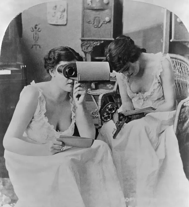 Framed Print : Two Young Women Studying Stereopticon Pictures