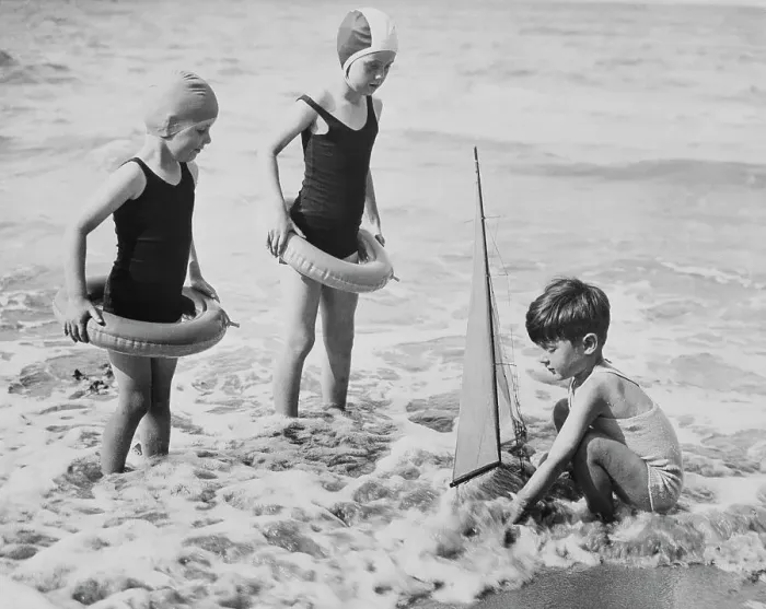 Framed Print : Youngsters Enjoying the Beach with Toy Sailboat Framed Print : Youngsters Enjoying the Beach with Toy Sailboat