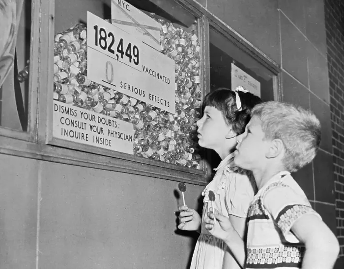 Framed Print : Youngsters Gazing up at Inoculation Statistics Display in Hallway