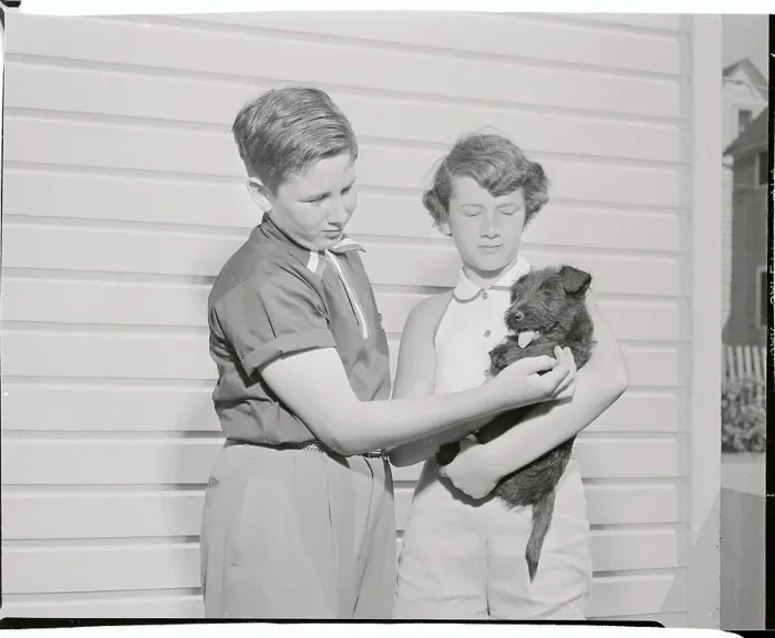 Framed Print : Youngsters Holding Black Scottie Pup Framed Print : Youngsters Holding Black Scottie Pup