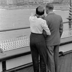 And Over There Print: A couple on Brighton pier And Over There Print: A couple on Brighton pier