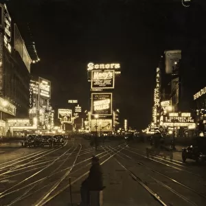 1921 View of the traffic and illuminated advertisements in Times Square at night