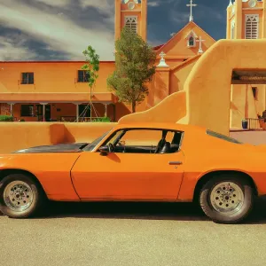 1970's Bright Orange Camaro and Adobe Church in the Southwest, USA 1970's Bright Orange Camaro and Adobe Church in the Southwest, USA