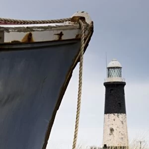 Abandoned boat and lighthouse, Humberside, England