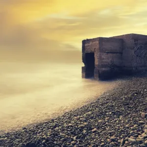 Abandoned bunker on the beach at sunrise Abandoned bunker on the beach at sunrise