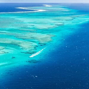 Aerial of Malolo reef with motorboat passing, Fiji