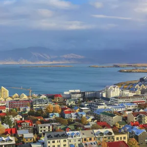 Aerial view over downtown Reykjavik with ocean and mountain at back, Iceland