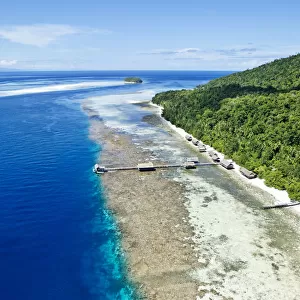 Aerial view of island jetty with sea and hill