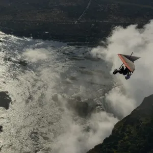 Aerial view of a micorlight (ultralight) flying over the Zambezi River and Victoria Falls. Livingstone. Zambia Aerial view of a micorlight (ultralight) flying over the Zambezi River and Victoria Falls. Livingstone. Zambia
