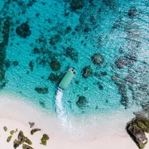 Aerial view of tropical beach and boat on clear water, Kerama Islands, Okinawa, Japan Aerial view of tropical beach and boat on clear water, Kerama Islands, Okinawa, Japan