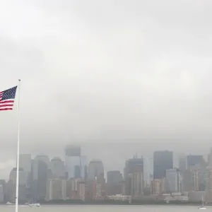 American national flag, view from Ellis Island towards the skyline of Manhattan in the fog, New York, USA, North America American national flag, view from Ellis Island towards the skyline of Manhattan in the fog, New York, USA, North America