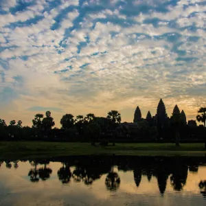 Angkor Wat temple at sunrise reflecting in water